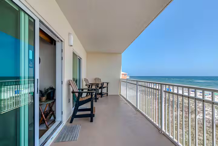 Spacious balcony with seating and panoramic Gulf views