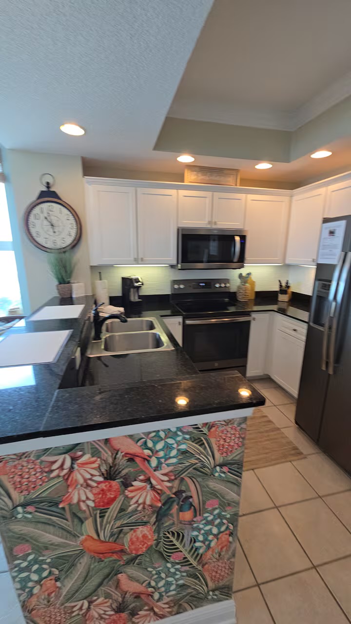 Fully equipped kitchen with stainless steel appliances and granite countertops