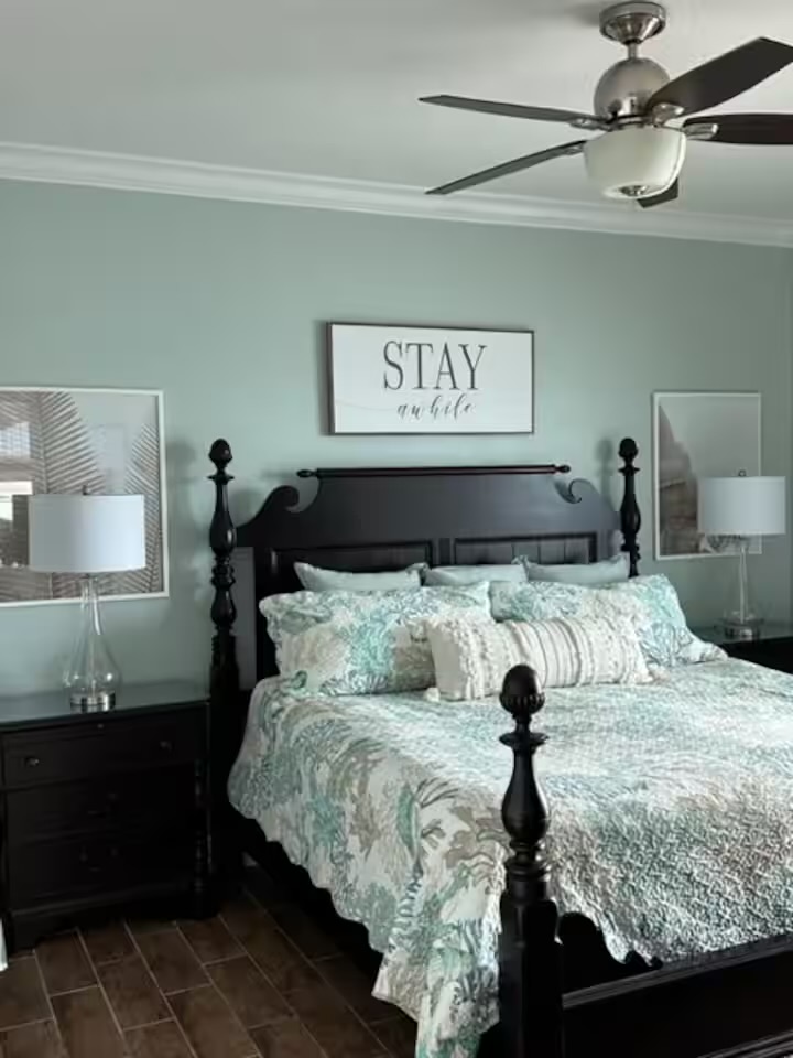 Master bedroom with four-poster bed and coastal decor