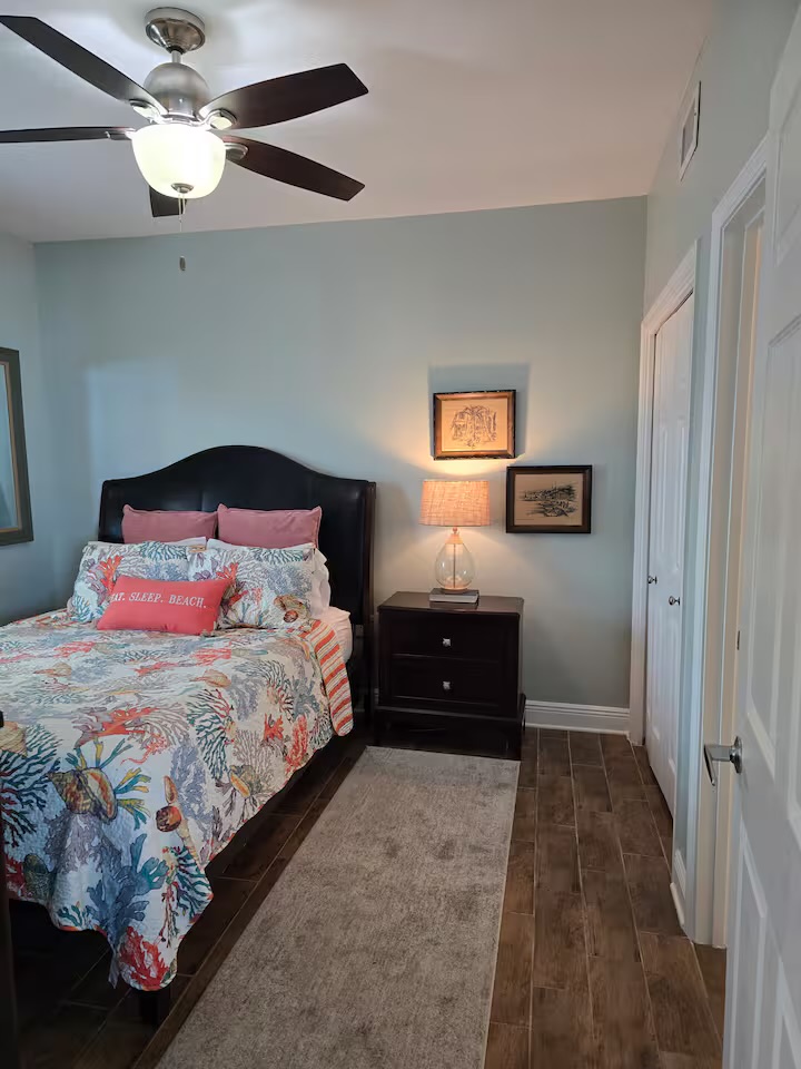 Second bedroom with comfortable bed and beach-themed decor